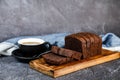 Chocolate Cake slice served on wooden board with cup of black coffee isolated on napkin side view of french breakfast baked food Royalty Free Stock Photo