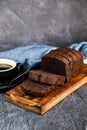 Chocolate Cake slice served on wooden board with cup of black coffee isolated on napkin side view of french breakfast baked food Royalty Free Stock Photo