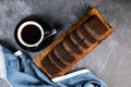 Chocolate Cake slice served on wooden board with cup of black coffee isolated on napkin top view of french breakfast baked food Royalty Free Stock Photo