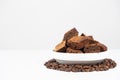 Chocolate cake sliced into squares in a white plate, brownie and coffee beans, space for text