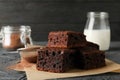 Chocolate cake slices, bottle of milk and strainer with powder on background, close up Royalty Free Stock Photo