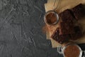 Chocolate cake slices, bottle of milk and strainer with powder on black background Royalty Free Stock Photo