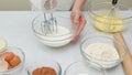 Chocolate cake step by step recipe. Woman hands beating egg whites with mixer Royalty Free Stock Photo