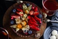 Chocolate cake with strawberries, bog whortleberry and Chocolate Easter quai eggs on wooden board