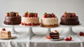 chocolate cake with strawberries A colorful photo of four different cakes on a white tablecloth. The cakes are round