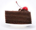 Chocolate cake with topping cherry in ceramic plate. Delicious cuisine dessert over white background Royalty Free Stock Photo