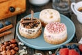 Chocolate cakes on a plate with berries and nuts. Composition of desserts on a wooden table