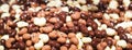 Chocolate candies background closeup. Chocolates candy made with black, white and milk chocolate. Chocolate covered nuts and raisi Royalty Free Stock Photo