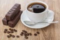 Chocolate candies, coffee beans, coffee in cup and spoon Royalty Free Stock Photo