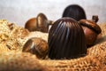 Chocolate candies with nuts on burlap in the sun