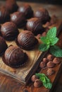 Chocolate candies on wooden table. A chocolate truffles on a wooden base with mint Royalty Free Stock Photo