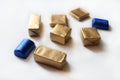 Chocolate candies wrapped in blue and golden foil isolated on white surface Royalty Free Stock Photo