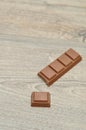 A chocolate candy bar with a piece broken off