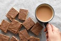 Chocolate caramel rice crispy treats and a cup of tea. Royalty Free Stock Photo