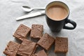 Chocolate caramel rice crispy treats and a cup of tea. Royalty Free Stock Photo