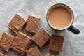 Chocolate caramel rice crispy treats and a cup of tea. Royalty Free Stock Photo