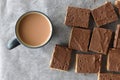 Chocolate caramel rice crispy treats and a cup of tea. Royalty Free Stock Photo