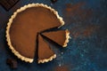 Chocolate and caramel tart on dark blue background Royalty Free Stock Photo