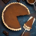 Chocolate and caramel tart on dark blue background Royalty Free Stock Photo