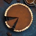 Chocolate and caramel tart on dark blue background Royalty Free Stock Photo