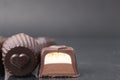 chocolate case candy in section with filling chocolate vanilla mousse ganache with peanut nut on a black background with space for Royalty Free Stock Photo
