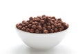 Chocolate cereal balls in a bowl isolated on white background Royalty Free Stock Photo