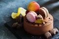 Chocolate cheesecake with banana filling decorated with macarons and toffee Royalty Free Stock Photo