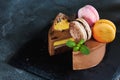 Chocolate cheesecake with banana filling decorated with macarons and toffee Royalty Free Stock Photo