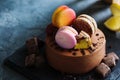 Chocolate cheesecake with banana filling decorated with macarons and toffee Royalty Free Stock Photo