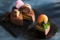 Chocolate cheesecake with banana filling decorated with macarons and toffee Royalty Free Stock Photo