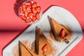 Chocolate cheesecakes with strawberries on pink abstract backgrount.