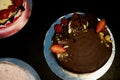 The chocolate cherry cake, decorated with strawberries, biscuits and strawberry shortcake. A masterpiece of culinary art Royalty Free Stock Photo