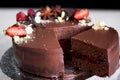The chocolate cherry cake, decorated with strawberries, biscuits and strawberry shortcake. A masterpiece of culinary art Royalty Free Stock Photo