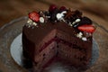 The chocolate cherry cake, decorated with strawberries, biscuits and strawberry shortcake. A masterpiece of culinary art Royalty Free Stock Photo