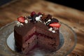 The chocolate cherry cake, decorated with strawberries, biscuits and strawberry shortcake. A masterpiece of culinary art Royalty Free Stock Photo