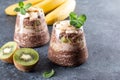 Chocolate chia pudding with fruits in a glass in almond milk. Healthy food