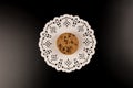 Chocolate chip cookies in beautiful white lace, black background. top view Royalty Free Stock Photo
