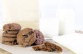 Chocolate chip cookies on brown paper and sack cloth with glass Royalty Free Stock Photo