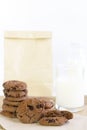 Chocolate chip cookies on brown paper and sack cloth with glass Royalty Free Stock Photo