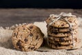 Chocolate chip cookies freshly baked on sackcloth on wooden table background. Homemade pastry. With copy space for text and logo Royalty Free Stock Photo