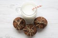 Chocolate chip cookies and glass jar of milk on a white wooden background, top view. Royalty Free Stock Photo