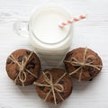 Chocolate chip cookies and glass jar of milk on a white wooden table, overhead view. Royalty Free Stock Photo