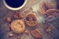 Chocolate chip cookies in glass jar on sack and coffee on wooden Royalty Free Stock Photo