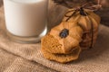 Chocolate chip cookies and a glass of milk on a on the hessian n Royalty Free Stock Photo