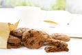 Chocolate chip cookies in paper bag and cup coffee with notebook Royalty Free Stock Photo