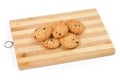 Chocolate chip cookies on wooden cutting board on white background Royalty Free Stock Photo