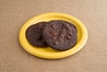 Chocolate chip crispy brownie cookies on yellow plate Royalty Free Stock Photo