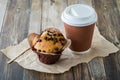 A chocolate chip muffin served with a coffee in a disposable cup. Royalty Free Stock Photo