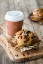 A chocolate chip muffin served with coffee in a paper recyclable cup. Royalty Free Stock Photo