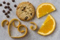 Chocolate chip and orange cookie. Orange peel in heart shape on grey background Royalty Free Stock Photo